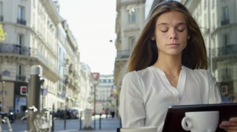 Young Lady working on her tablet while at a local cafe. Stock Footage 63032458