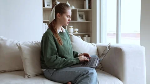 Young lady works at lap top at home Stock Footage 248090337