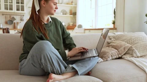 Young lady works at lap top at home Stock Footage 250128164