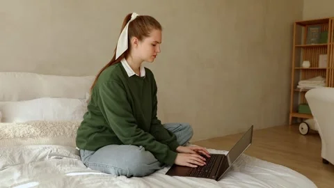 Young lady works at lap top at home Stock Footage 250288192