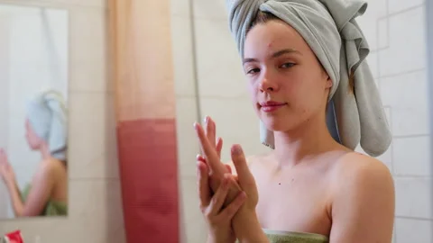Young Lady Wrapped in Light Green Towel Rubbing Hands Together with Mirror Stock Footage 308594629