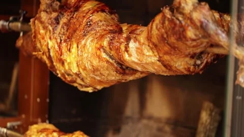 Young lamb is cooked on a spit in a restaurant in Istanbul.FullHD.24 sec Stock Footage 320064270