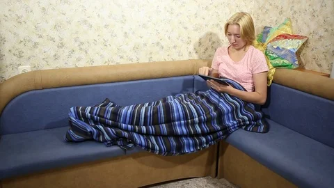 Young lass reading posts on social networks on tablet pc Stock Footage 69826936