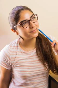 Young Latin American ethnicity thinking with a pencil Stock Photos