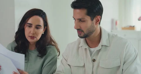 Young Latin couple on laptop computer check document paper pay bills online. Stock Footage 337040209