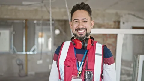 Young latin man builder smiling confident taking out glasses at constructio.. 스톡 동영상 243496479