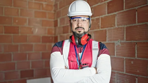 Young latin man builder standing with relaxed expression and arms crossed g.. Stock Footage 241146874