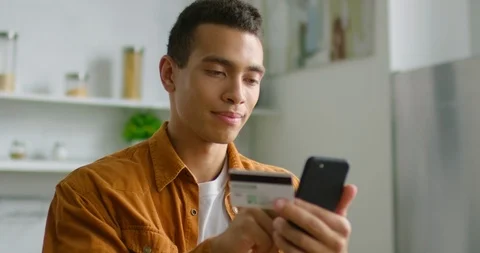 Young latin man is doing online shopping at home, close up 스톡 동영상 113293395