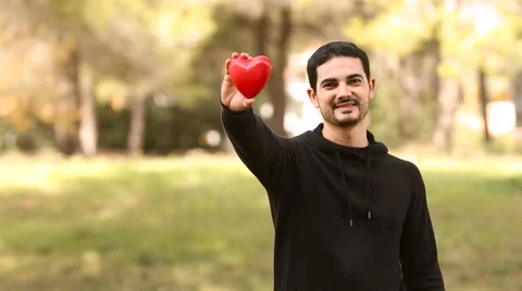 Young latin man with a heart shape Stock Footage 63856691