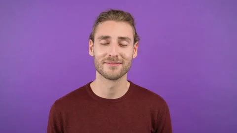 Young latin man taking a break and relaxing with closed eyes isolated on purple Stock Footage 147203514