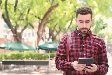 Young latin man using a tablet Stock Photos