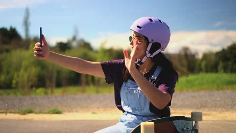 Young latin surf skater taking selfie and video calling with smartphone Stock Footage 308742833
