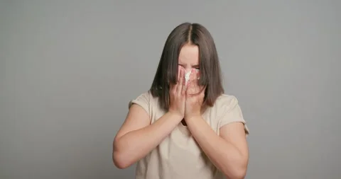 Young latin teen girl with allergy sneezing. Girl feeling sick having runny nose Stock Footage 264201827