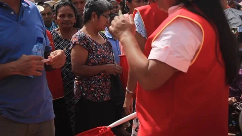 Young Latin women picking up the tithe during a religious event Stock Footage 86519097