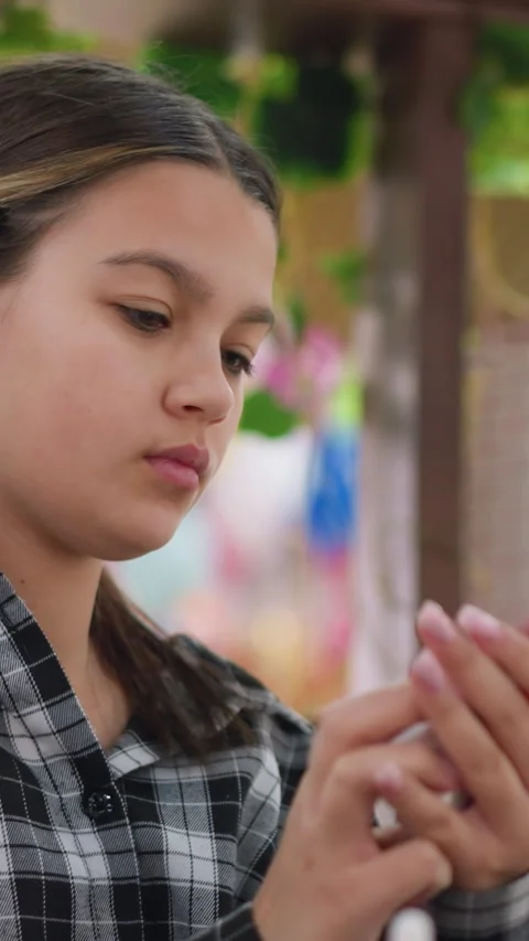 Young Latina preparing her nails, Calm teenage girl in natural light doing Stock Footage 330718342