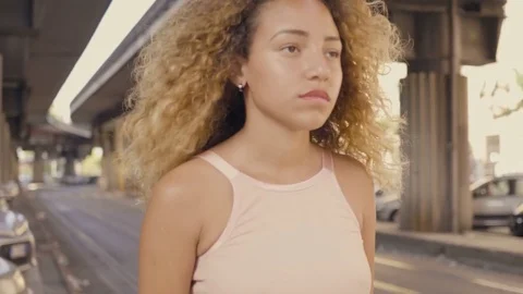 Young latina woman going alone and sad around the city Stock Footage