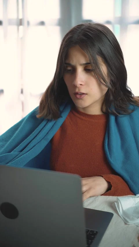 Young Latina woman using her laptop at home while experiencing discomfort, feeli Stock Footage 346327375