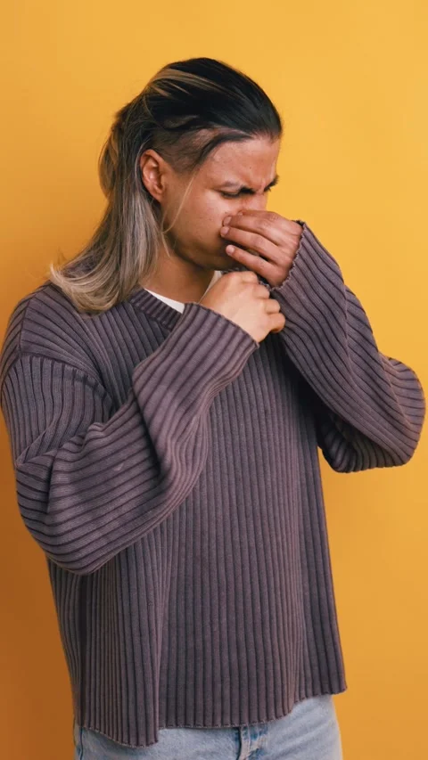 Young latino man feeling sick and nauseous on a yellow background. Vertical Stock Footage 333074372