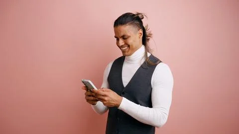 Young latino man smiling using smartphone Stock Photos