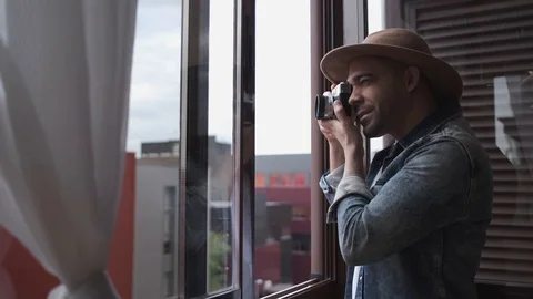 Young Latino Man Taking Pictures From Window at Home During Confinement. Stock Footage 129262053