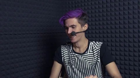 Young laughing man with purple bangs in web studio Stock Footage 70803083