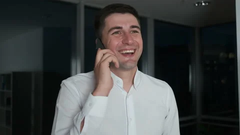 A young lawyer lingered at work until night standing by a panoramic window and Stock Footage 135421367