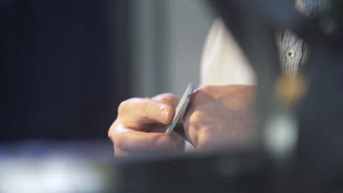 Young leather craftsman creates a DIY product. Master in factory of leather. Stock Footage 130214903