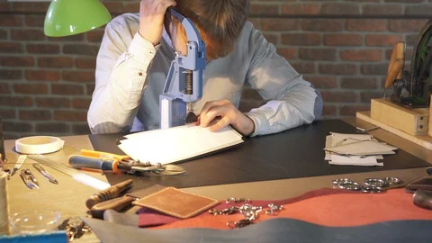 Young leather craftsman, workshop owner works in workplace. Handmade handicraft. Stock-Footage 130145053