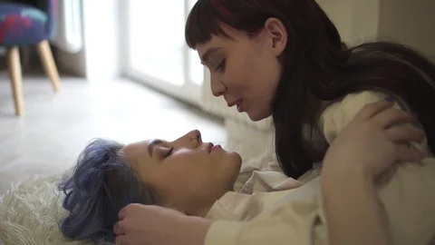 Young lesbian couple talking and kissing... | Stock Video