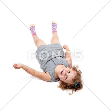 Young little girl lying over isolated white background Stock Photos