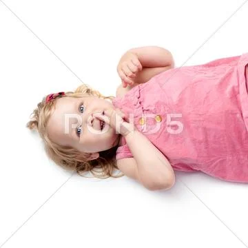 Young little girl lying over isolated white background Stock Photos