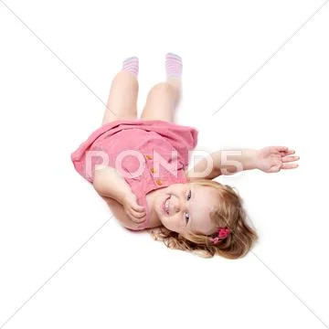 Young little girl lying over isolated white background Stock Photos
