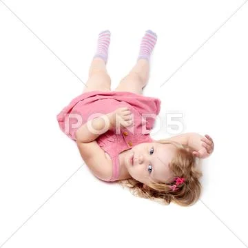 Young little girl lying over isolated white background Stock Photos