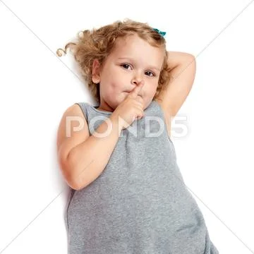 Young little girl lying over isolated white background Stock Photos
