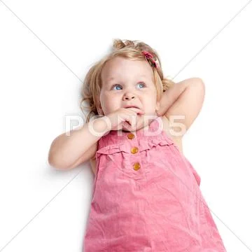 Young little girl lying over isolated white background Stock Photos