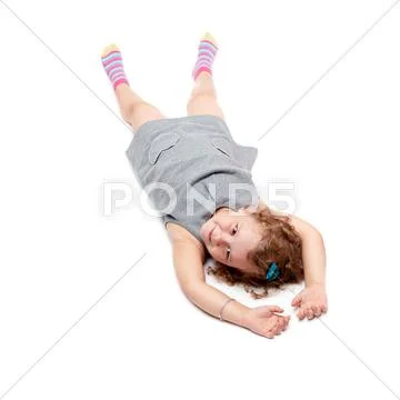 Young little girl lying over isolated white background Stock Photos