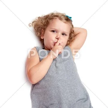 Young little girl lying over isolated white background Stock Photos