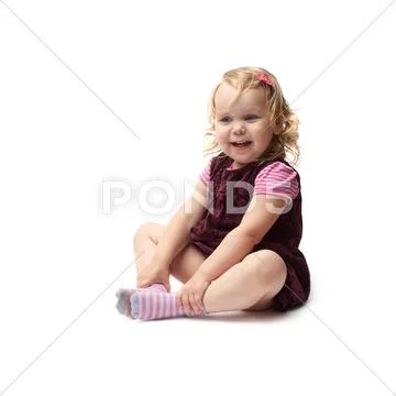 Young little girl sitting over isolated white background Stock Photos