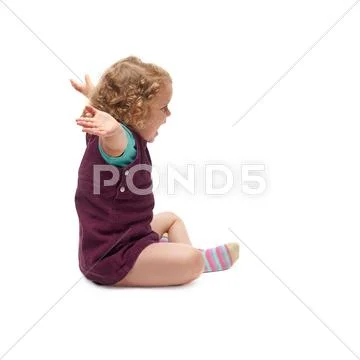 Young little girl sitting over isolated white background Stock Photos