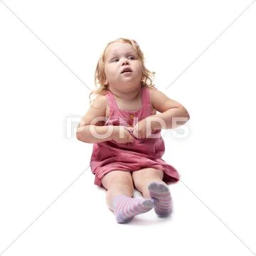 Young little girl sitting over isolated white background Stock Photos