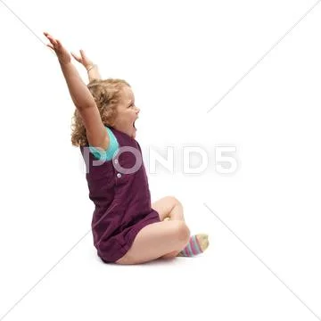 Young little girl sitting over isolated white background Stock Photos