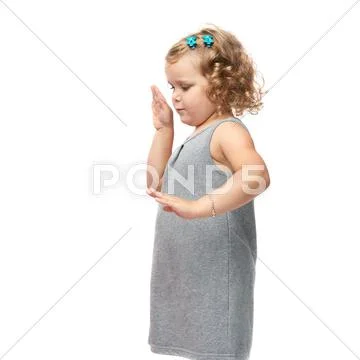 Young little girl standing over isolated white background Stock Photos