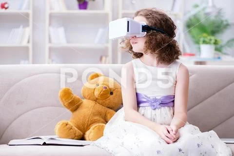 Young little girl with VR virtual reality glasses Stock Photos