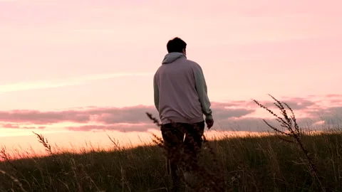 Young lonely guy walks at sunset. evening time of day. Stockbeeldmateriaal 162263114