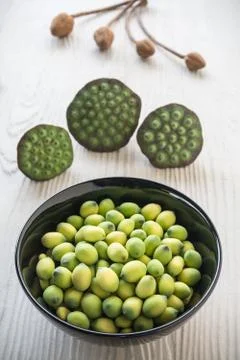 Young lotus seeds in black bowl, eaten as snack in local Thailand Stock Photos