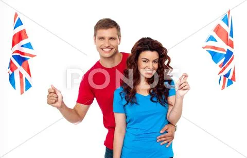 Young love couple embracing and holding national flag Stock Photos