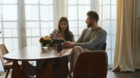 Young love sit at table and use tablet Stock Footage 266810717