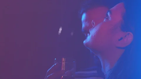 Young lovers flirting and drinking in the dark of night club Video stock 103515537