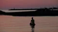 young lovers play in the sea at sunset - boy and girl play in the sea HD Footage
