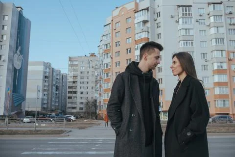 Young loving couple with coffee on black industrial background Stock Photos